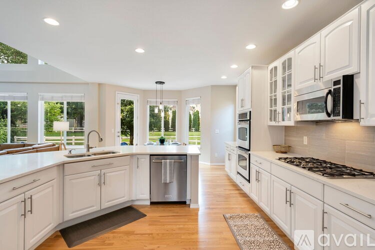 A kitchen with white cabinets and a dishwasher.