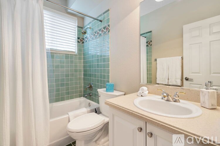 A white toilet sits next to a sink in a bathroom.
