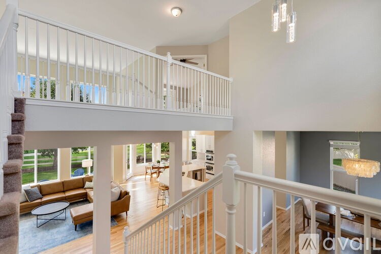 A large open living area with a staircase leading to the upper floor.