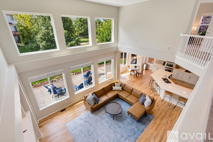 A sunny day outside the windows of a spacious living room.
