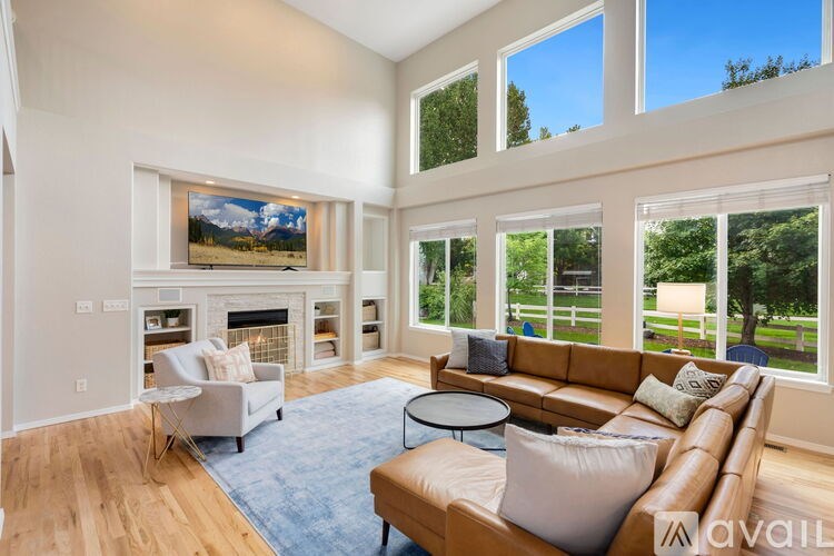 A living room with a fireplace and a painting on the wall.