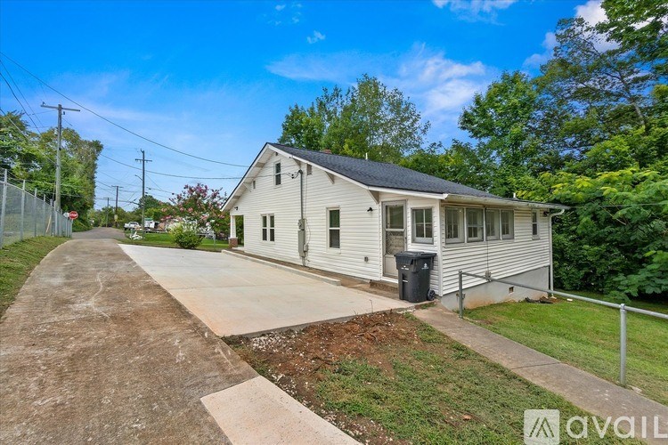A single-story house with a driveway in front.