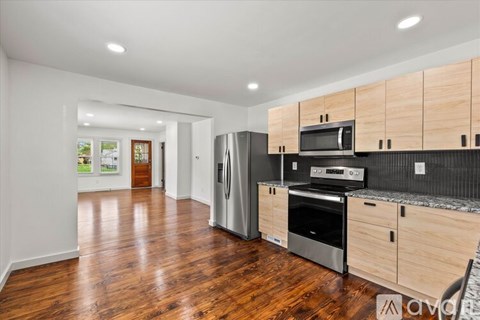A kitchen with wooden cabinets and stainless steel appliances.