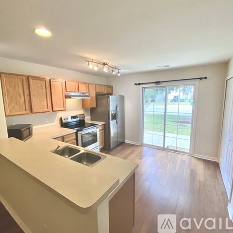 A kitchen with wooden cabinets and stainless steel appliances.