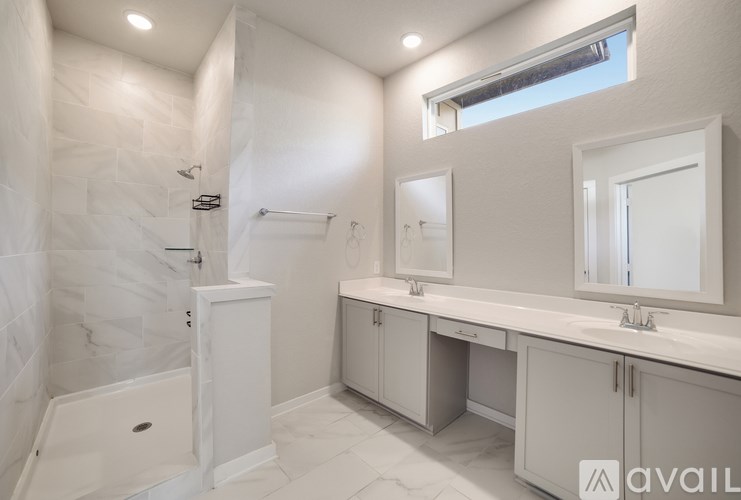 A white bathroom with a tub, sink, and mirror.