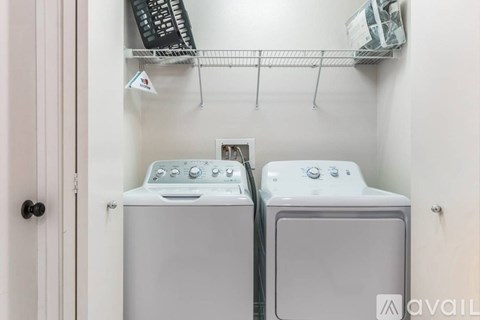 Two front loading washing machines in a small laundry room.