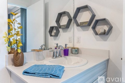 A bathroom with a white countertop and a blue towel.