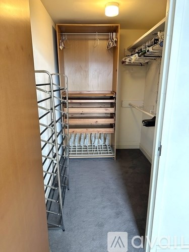 A small room with a bunk bed and a shelf.