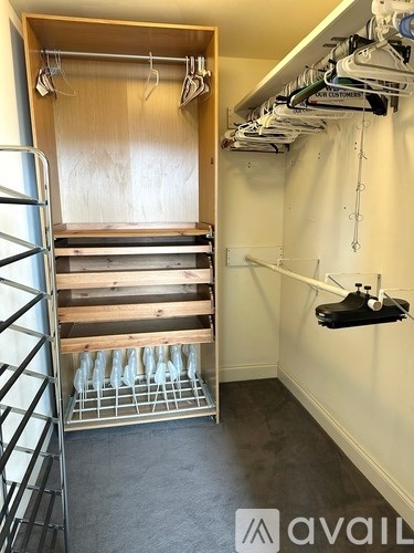 A room with a rack of clothes hanging on the wall.