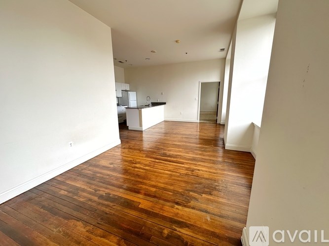 A room with wooden floors and white walls.