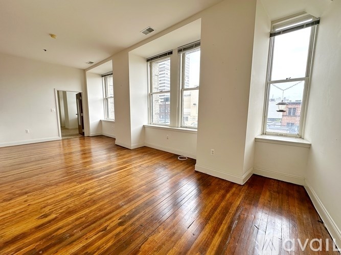 A room with wooden floors and white walls.