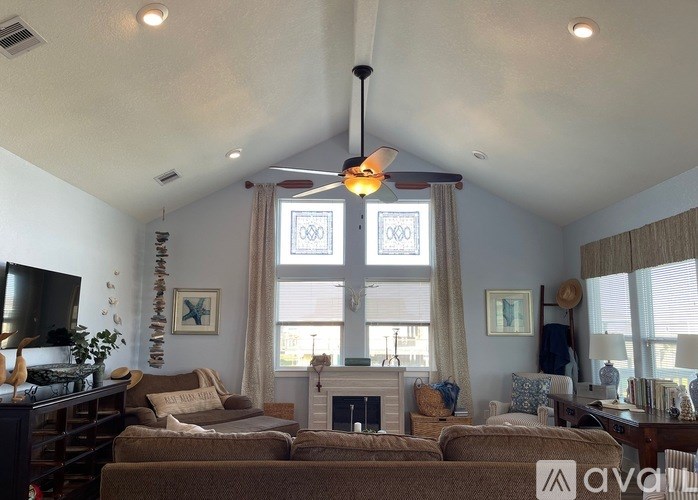 A living room with a fireplace and a large window.