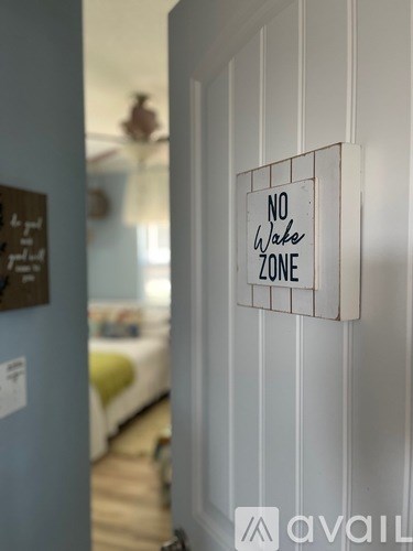 A sign on a door reads "No Wake Zone".