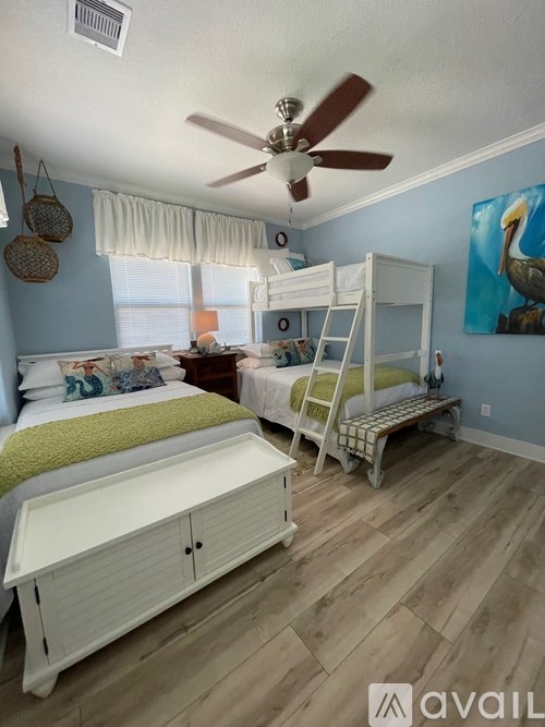 A room with two bunk beds and a white dresser.