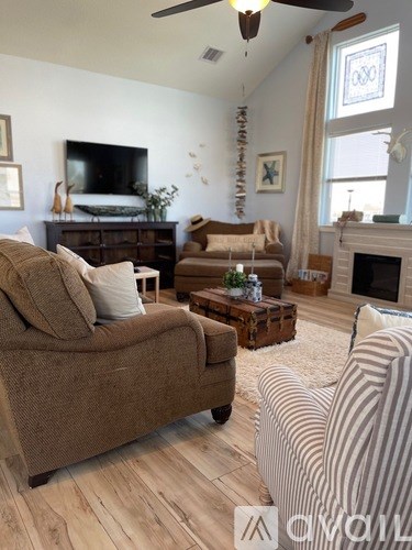 A living room with a fireplace and a striped armchair.
