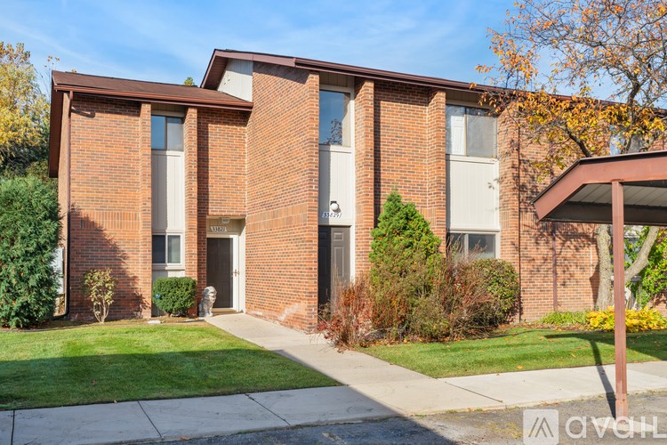 A brick building with a white door and windows.