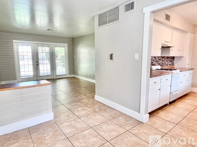 A kitchen area with a counter and cabinets.