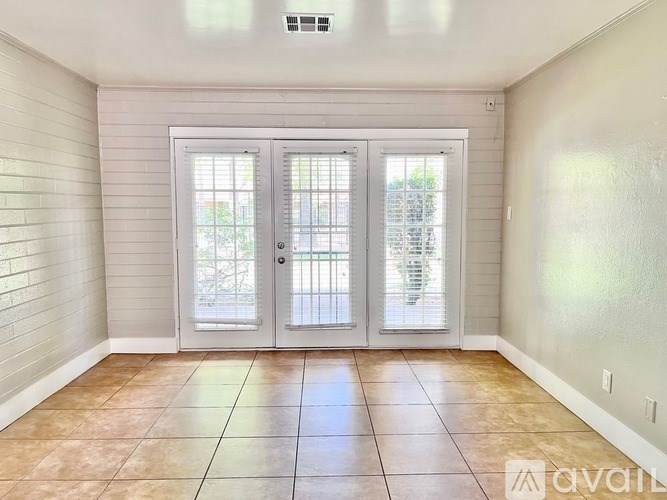 A room with a tiled floor and a sliding glass door.