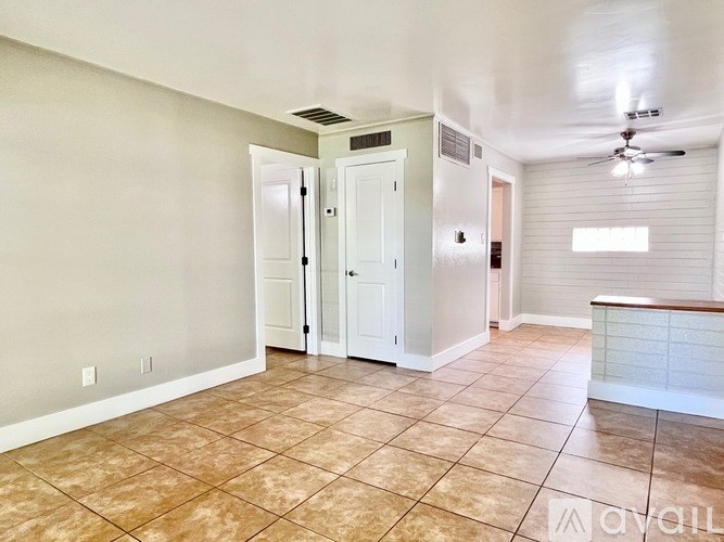 A room with a tiled floor and a ceiling fan.