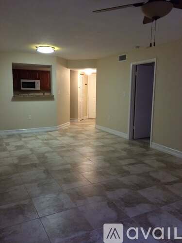 A room with a tiled floor and a ceiling fan.