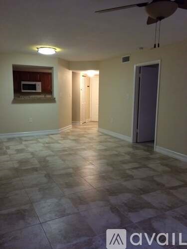 A room with a tiled floor and a ceiling fan.