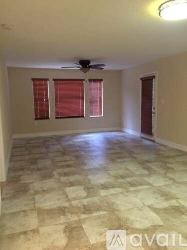 A room with a tiled floor and a ceiling fan.