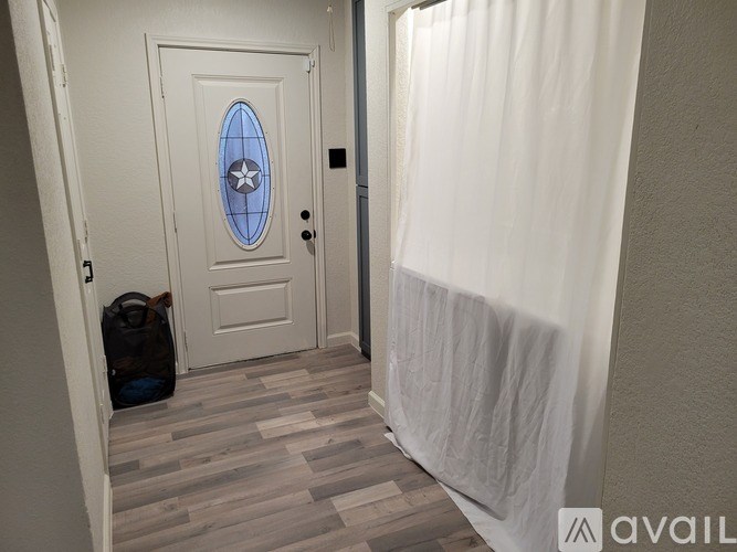 A white door with a blue star design in the middle.