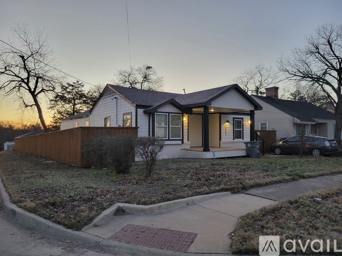 A house with a car parked in front of it.