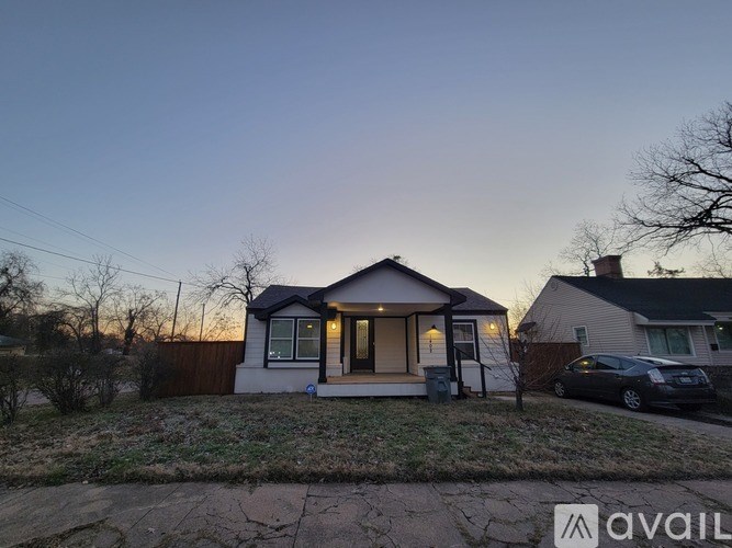 A house with a car parked in front of it.