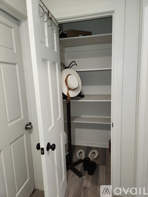 A white closet with a hat on a hanger.