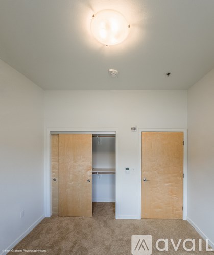 A room with two doors and a carpeted floor.