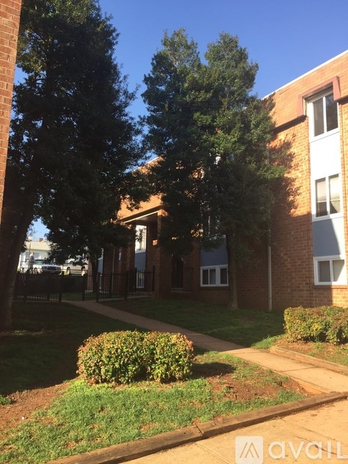 A building with a green bush in front of it.