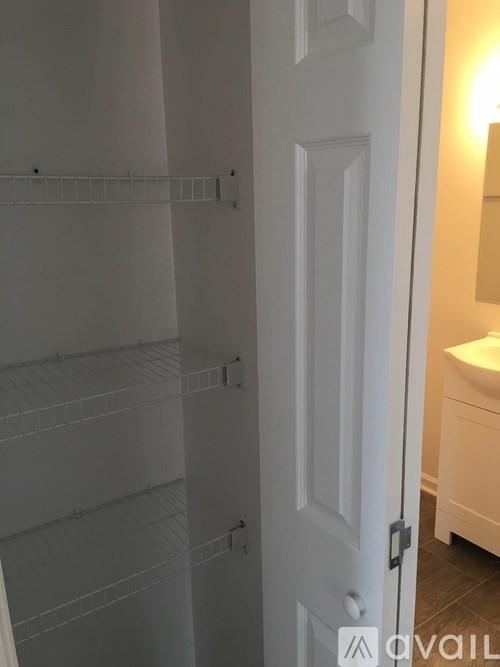 A white door with a mirror on the other side.