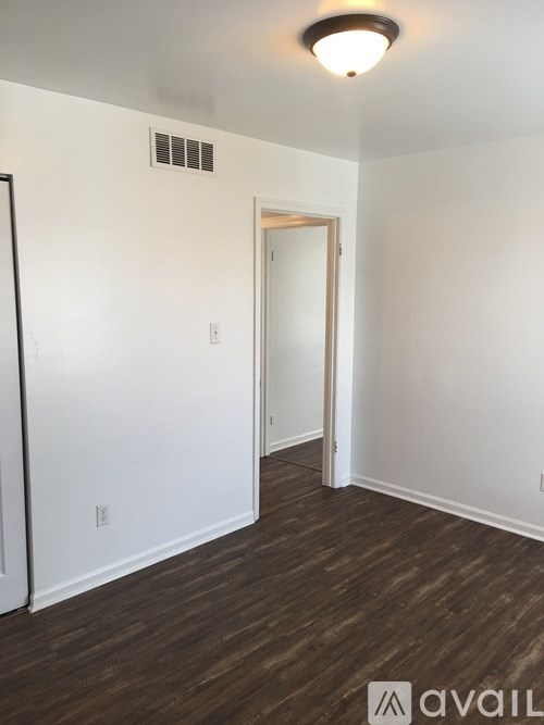 A room with a white wall and a door.