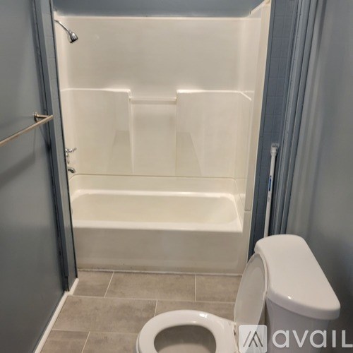 A white toilet is next to a bathtub in a bathroom.