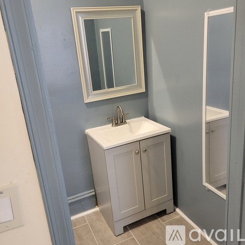 A bathroom with a sink and a mirror.