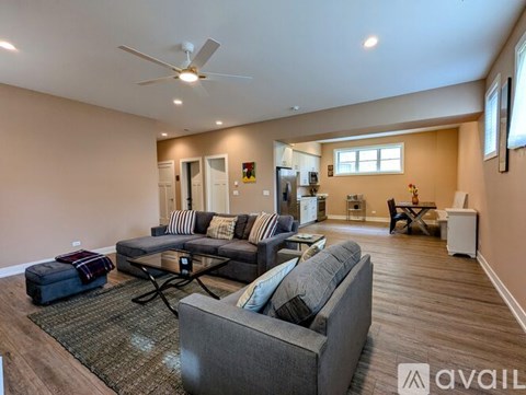 A living room with a grey couch and a black coffee table.