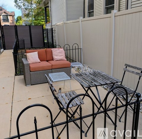 A patio with a table, chairs, and a couch.