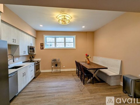 A kitchen with a table and chairs in the middle of the room.