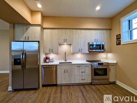 A kitchen with wooden cabinets and stainless steel appliances.