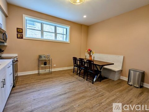 A kitchen with a dining table and chairs is available for rent.