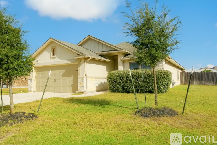 A house with a garage and a driveway is for sale.