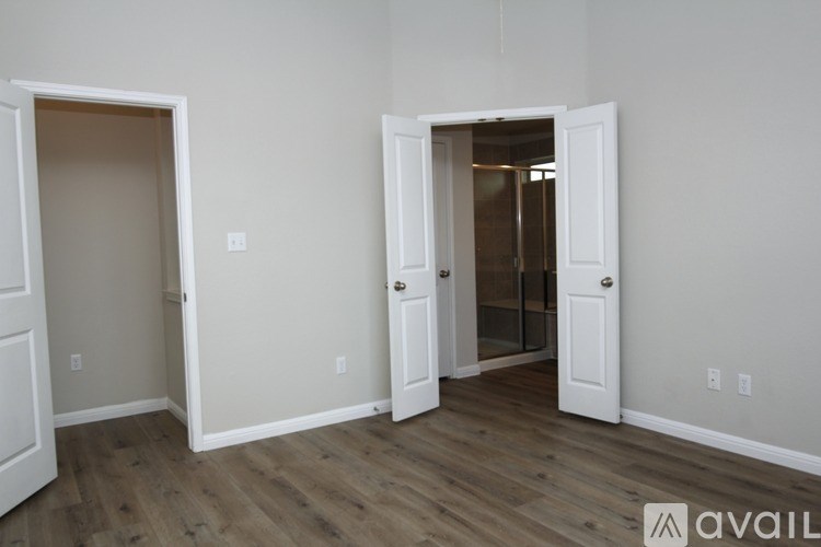 A room with two doors, one of which is open.