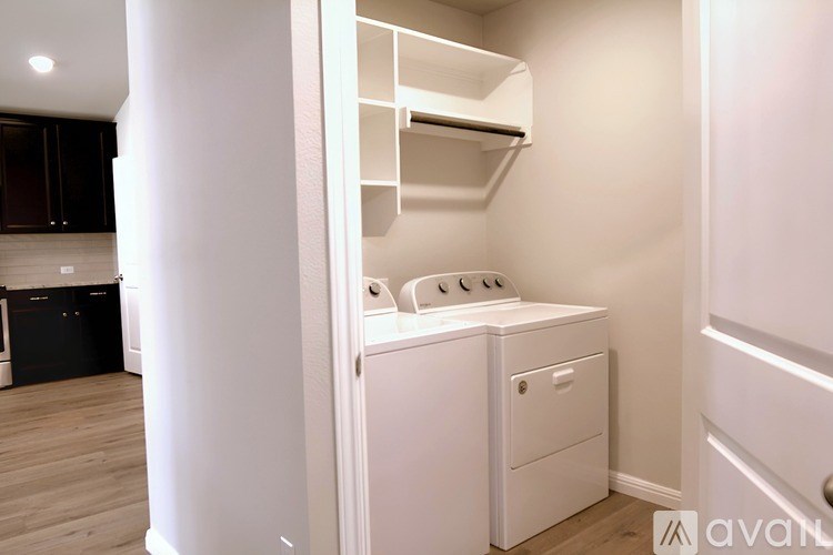 A white washing machine and dryer in a small laundry room.