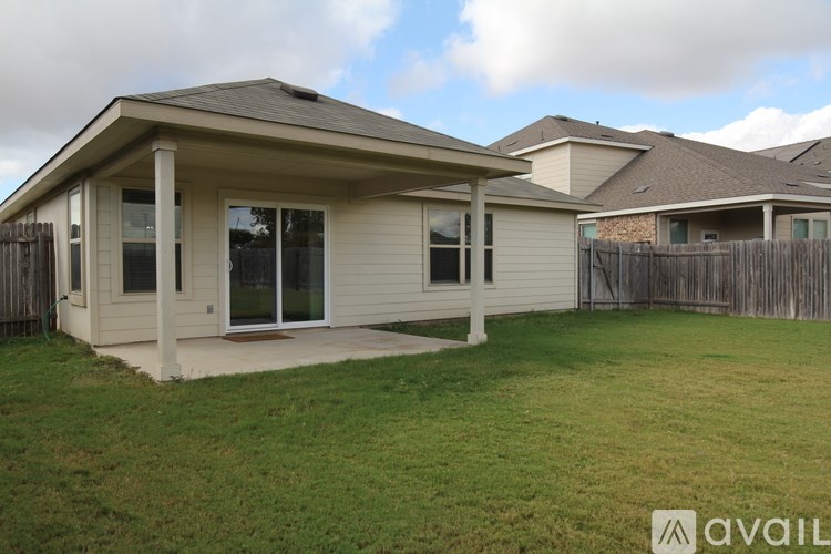 A house with a covered patio is for sale.