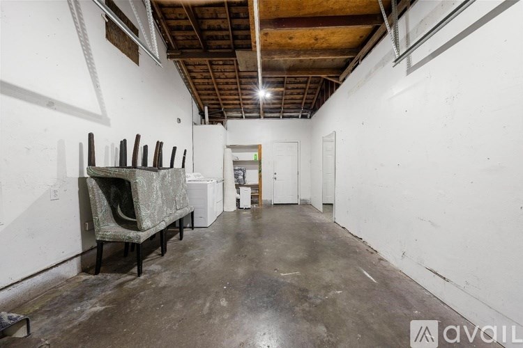 A room with a couch and a chair in it.