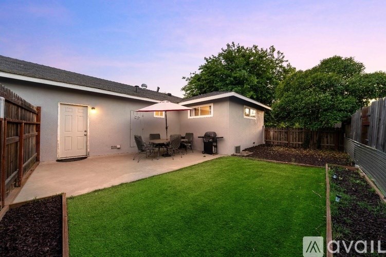 A backyard with a lawn and a shed.