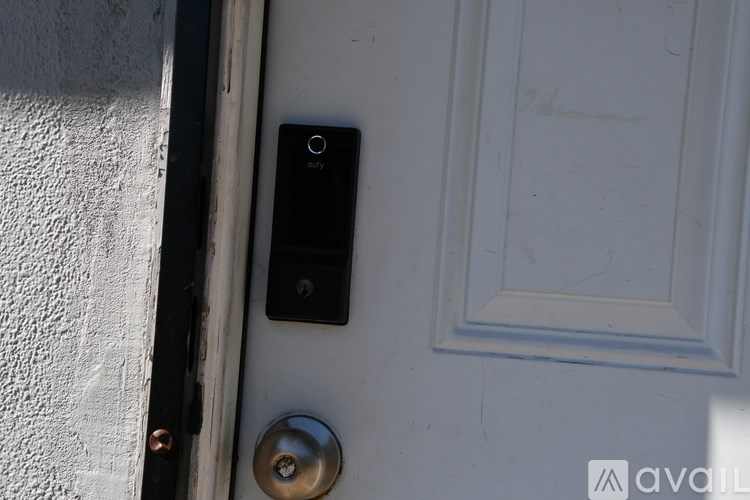 A doorbell mounted on a white door.