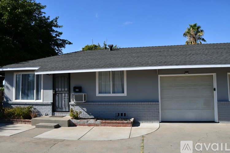 A house with a garage door and a driveway.