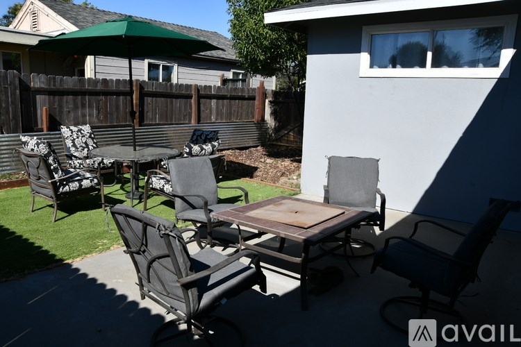 A patio with a table and chairs.